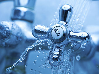 cold water know in a shower with water splashes off it