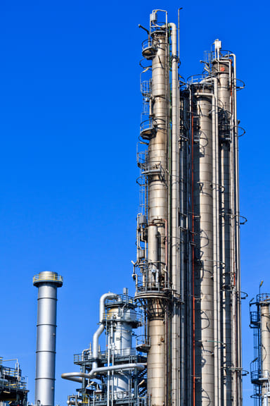 gas pipes reaching against the sky